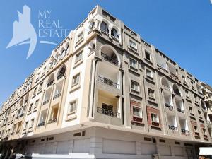 a white building with windows and balconies on it at One Bedroom with Balcony WI-FI Downtown Sheraton Plaza 226 in Hurghada