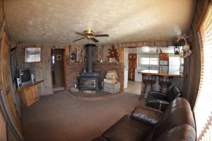 a living room with a couch and a wood stove at Wild West Retreat in Escalante