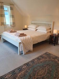 a bedroom with a large bed and a rug at Villa Muneera - rural retreat in the heart of Pembrokeshire in Narberth