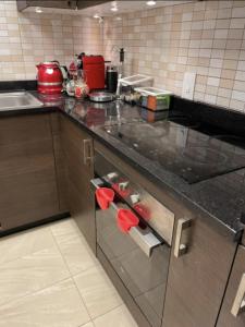 a kitchen with a sink and a counter top at Stylish One bedroom with all amenities, close to downtown1 in Dubai