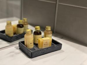 a group of bottles of honey on a tray at Private Modern Apartment in Olton