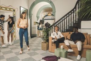 a group of people standing in a living room at The Pacific House in Sydney