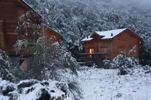 a cabin with snow on the ground in front of it at Chalet 6B dans les Pyrénées proche d'Andorre in LʼHospitalet-près-lʼAndorre