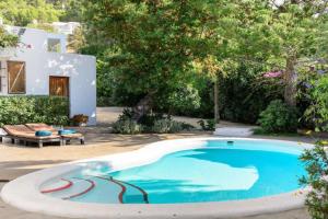 a swimming pool in front of a house at Villa Can Cozy in Ibiza Town