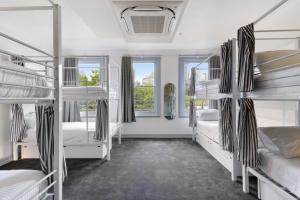 a room with four bunk beds and a window at The Pacific House in Sydney +73 photos