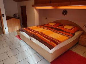 a bedroom with a large bed with a wooden headboard at Haus-Brecherspitzblick in Schliersee