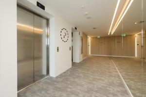 a hallway of an office building with a glass door at Pinea 718 SeaView in Pobierowo +15 photos