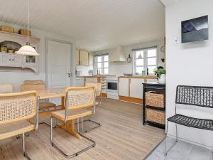 a kitchen and dining room with a table and chairs at Holiday home Hvide Sande XIX in Hvide Sande