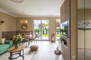 a living room with a green couch and a table at Balatonic Relax in Zamárdi