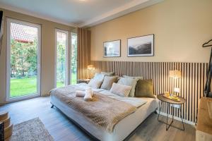 a bedroom with a large bed and a window at Balatonic Relax in Zamárdi