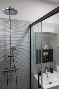 a bathroom with a sink and a glass shower at Balatonic Relax in Zamárdi