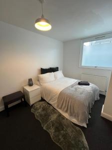 a bedroom with a large bed and a window at Archway Apartment in London