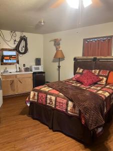 a bedroom with a bed and a kitchen at Acorn Hideaways Canton Old Western Ranch Hands' Suite in Canton
