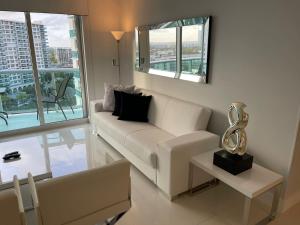 a living room with a white couch and a table at Hollywood on Beach Apartment in Hollywood