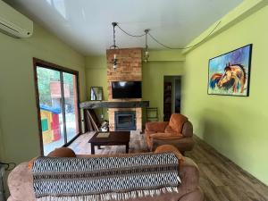 a living room with two couches and a fireplace at NATURALMENTE in Santa Ana