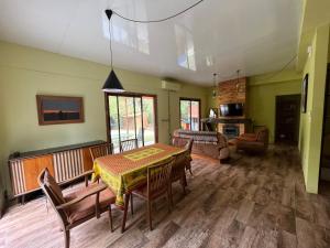 a living room with a table and chairs and a couch at NATURALMENTE in Santa Ana