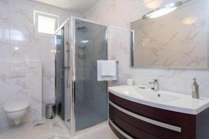 a bathroom with a sink and a shower at Holiday Villa Natura in Orebić +46 photos