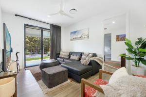 a living room with a couch and a table at Casa Bella 3 Bedroom in Coffs Harbour +25 photos
