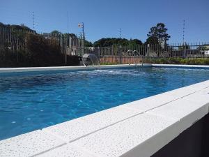 a swimming pool with a fountain in the middle at Incomparable Vista al Golf in Mar del Plata
