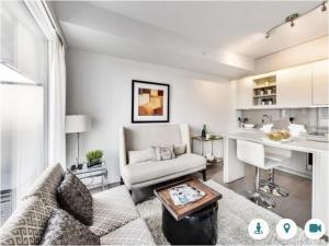 a living room with a couch and a table at Comfortable Central Downtown Condo - in Toronto