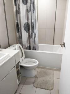 a white bathroom with a toilet and a shower at Comfortable Central Downtown Condo - in Toronto