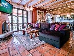 a living room with a couch and a table at VILLA APU CHICON (Apu Wasi & Inti Wasi) in Urubamba