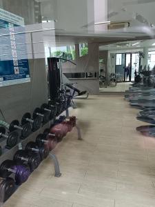 a gym with rows of dumbbells on the wall at Acqua Condominium Jomtien in Jomtien Beach