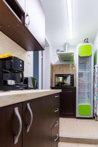 a kitchen with brown cabinets and a green refrigerator at Luxury Studio for 3 persons, near Carevec, Veliko Tarnovo in Veliko Tŭrnovo