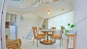 a kitchen and dining room with a table and chairs at Coral Garden 7 Pools in Yomitan