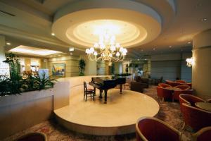 a lobby with a grand piano in a waiting room at Hotel Listel Inawashiro Wing Tower in Inawashiro