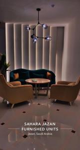 a living room with a couch and a table at رواق الضيافة للشقق المخدومة RWAQ Hotel in Jazan