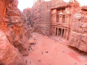a group of people standing in a river in a canyon at Petra Sella Hotel in Wadi Musa