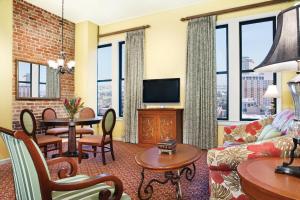 a living room with a couch and a tv at Club Wyndham La Belle Maison in New Orleans