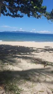 a view of a beach with the ocean in the background at Orchid Island B&B on the River with Pool & Jetty in Pacific Harbour