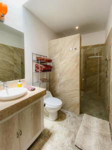 a bathroom with a toilet and a sink and a shower at Luxury Suite, Bellas Villas, Villa LUNA in San Miguel de Allende