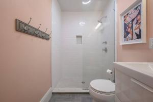 a white bathroom with a toilet and a shower at Blue Bay Suite! Near Downtown and Foodie Hot Spots in Tampa +10 photos