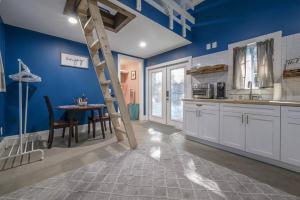 a kitchen with a ladder in a blue wall at Blue Bay Suite! Near Downtown and Foodie Hot Spots in Tampa