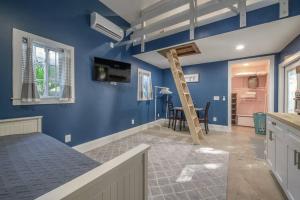 a kitchen with blue walls and a wooden ladder at Blue Bay Suite! Near Downtown and Foodie Hot Spots in Tampa