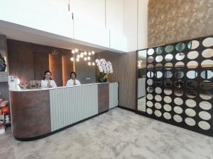 two women standing at a counter in a restaurant at ABC@48 Hotel & Service Apartment in Bangkok