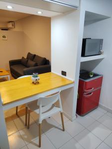 a living room with a table and a couch at El Racimo in Ciudad Lujan de Cuyo +11 photos