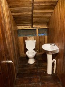 a bathroom with a toilet and a sink at Guest House Great Hostels Amazon in Puyo