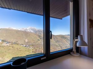 a window with a view of a mountain at Appartement Saint-Lary-Soulan, 2 pièces, 6 personnes - FR-1-296-449 in Saint-Lary-Soulan
