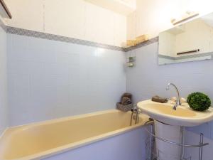 W łazience znajduje się umywalka, wanna i umywalka. w obiekcie Charmant appartement 6 pers. proche pistes de ski avec parking et équipements modernes - FR-1-296-449 w mieście Saint-Lary-Soulan
