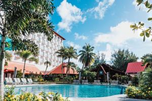 a view of the resort with a swimming pool and palm trees at Crowne Plaza Resort Saipan in Garapan