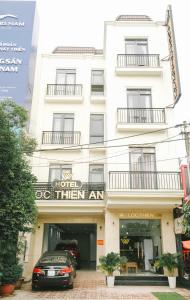 a white building with a sign that reads hotel then at Lộc Thiên Ân hotel in Bien Hoa