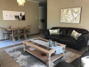 a living room with a couch and a table at Anne's Place in Potchefstroom