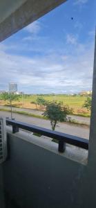 a window with a view of a road and a tree at San Remo Oasis in Cebu City