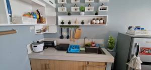 a small kitchen with a sink and a refrigerator at San Remo Oasis in Cebu City