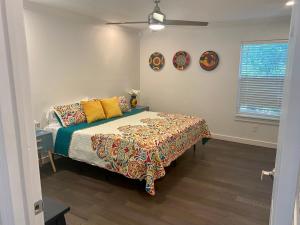 a bedroom with a bed and two plates on the wall at Alamo City Haven in San Antonio