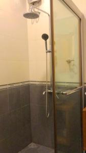a shower with a glass door in a bathroom at Rangali Etos Guraidhoo in Guraidhoo